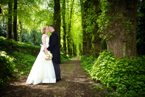 wedding couple pictured historic tree lined lime avenue, Pentillie Castle Cornwall