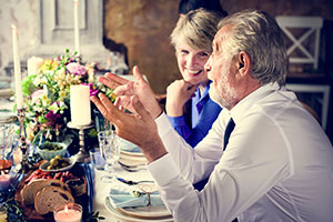 dementia-wedding-Including wedding guests with dementia in your big day - two mature guests chat at the table