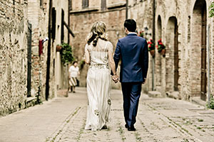 Your destination wedding: Top 10 steps for success - couple walk down narrow street in old town