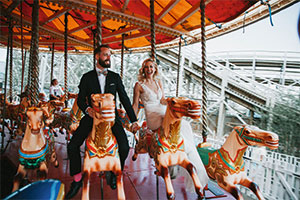 couple on carousel at wedding location