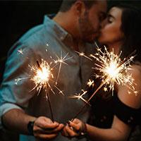 Couple with sparklers kissing