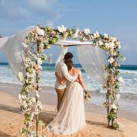 Couple under arch at overseas wedding