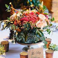 Summer wedding centre piece surrounded by candles