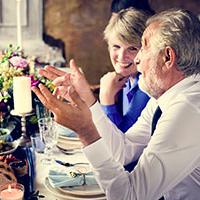 dementia-wedding-Including wedding guests with dementia in your big day - two mature guests chat at the table