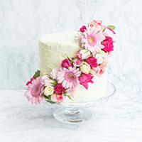 DIY wedding cake with pink flowers wrapping the cake
