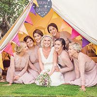 Girls sat in glamping tent at wedding