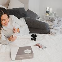 Woman using Teeth Straightening kit on bed