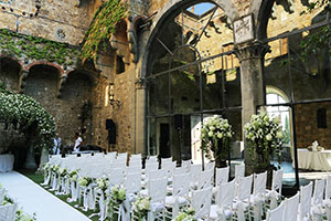 Wedding ceremony with white chairs and lots of greenery at a destination wedding